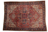 Vintage Heriz carpet, central quatrefoil medallion, geometric field, brick red, navy, jade green.