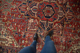Vintage Heriz carpet with intricate geometric vinery and palmettes in brick red and jade green.