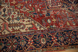 Vintage Heriz rug with navy geometric main border and red, ivory floral vinery.
