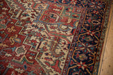 Heriz carpet border with navy, red, ivory, and jade green trefoil floral vinery.