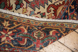Heriz carpet's ivory fringe and detailed hand-knotted weave at the edge.