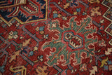 Hand knotted Heriz carpet showcasing geometric jade green vinery and brick red motifs.