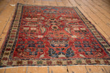 Cherry red vintage Persian rug field, with star-patterned border and mostly even wear.