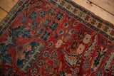 Vintage Northwest Persian rug showcasing unique boteh paisley and Herati-style florals in cherry red.