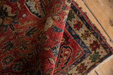Vintage Northwest Persian rug's curled cherry red pile with indigo and sand floral patterns.