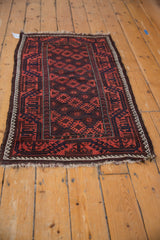 Antique Belouch rug corner, madder geometric patterns, ivory border, goat hair selvage, fringe loss.