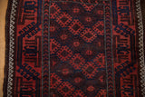 Antique Belouch rug's geometric floral palmettes in madder root and navy, with varied pile.