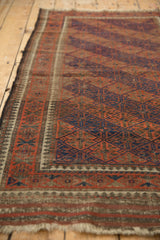 Vintage Belouch rug: paneled lattice, reciprocating pawn border, and tattered fringe.