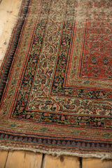 Antique Serbend rug corner with madder red and navy reciprocating pawn and vine borders; tattered edge.