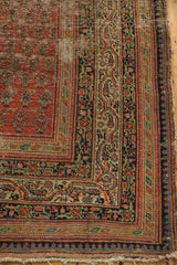 Antique Serbend rug corner: madder red boteh field, vine border, pawn motif, visible foundation wear.