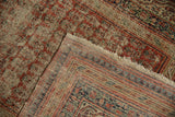 Antique Serbend rug detail: red, navy pawn motif borders and tattered edge.