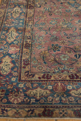 Vintage Persian Yezd rug detail: unusual purple field, scrolling vinery, and indigo floral border.