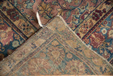 Vintage Yezd rug back, showing intricate hand-knotted foundation, secured selvage, and worn floral pile.