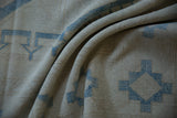 Faded denim blue geometric patterns and textured ivory distressed Oushak rug pile.