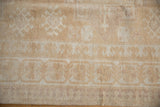 Vintage Distressed Oushak Carpet, beige and ivory geometric trefoil and pawn border patterns.