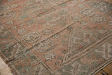 Distressed Melas rug close-up: pale dusty rose and oxidized silver octagonal guls, time-softened texture.