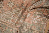 Textured pile of the distressed vintage Melas rug in pale dusty rose, ivory, and oxidized silver.