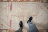 Abrashed ivory field with faded copper, raspberry, and stepped geometric motifs on Oushak runner.