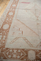 Distressed vintage Oushak runner with copper stepped field motifs and patterned border.