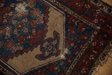 Hamadan rug detail: stepped beige medallion, indigo field, madder root Herati motifs, wear.
