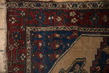 Vintage Hamadan rug corner reveals madder root, indigo vinery, beige field, and pile wear.