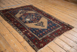 Vintage Hamadan rug corner, showing tattered madder root border and frayed fringe.