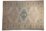 Vintage Distressed Oushak Carpet with geometric floral motifs in ivory, dusty pink, pale denim blue.