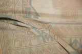 Distressed texture and worn geometric patterns in ivory, dusty pink, pale blue.