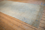 Decorative distressed Oushak runner, faded ivory and pale sand abrash with muted blue motifs.