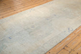 Distressed Oushak runner pile, highlighting faded ivory and dusty denim blue patterns.