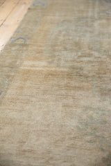 Distressed vintage Oushak rug's short pile, featuring abrashed ivory, beige, and sand tones.