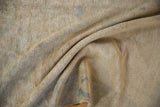 Distressed vintage Oushak rug with soft folds, showing its short pile and subtle abrash in beige and dusty blue.
