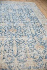 Distressed vintage Sparta rug detail, pale navy blue trellis with ivory, sand tones.
