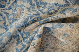 Distressed navy and ivory Sparta rug pile revealing hand-knotted foundation.
