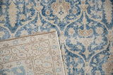 Close-up of the distressed Sparta carpet's worn pile, showing foundation and hand-knotted reverse.