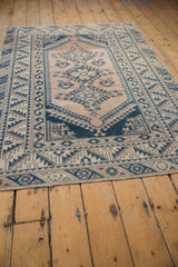 Distressed vintage Melas rug, showcasing geometric serrated borders and an abrashed field.