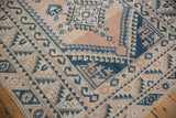 Distressed vintage Melas corner: indigo blue serrated leaves, wave motif, abrashed beige field.