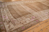 Distressed Kars carpet border with pink floral buds and textured seed field.