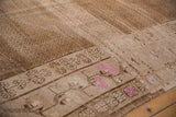 Distressed Turkish Kars carpet detail: faded pink floral border and subtle allover seed pattern.