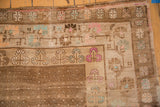 Distressed Kars rug corner: pale coffee brown field, seed design, pink and aqua blossom motifs.