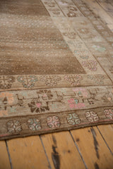 Distressed vintage Kars carpet pile, showcasing allover seed design and pastel floral border.