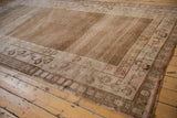 Distressed Kars carpet border, meandering vine and floral bud motifs in pale coffee brown.