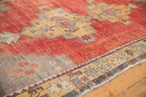 Distressed Oushak rug corner with saffron yellow geometric border and gray spandrel.