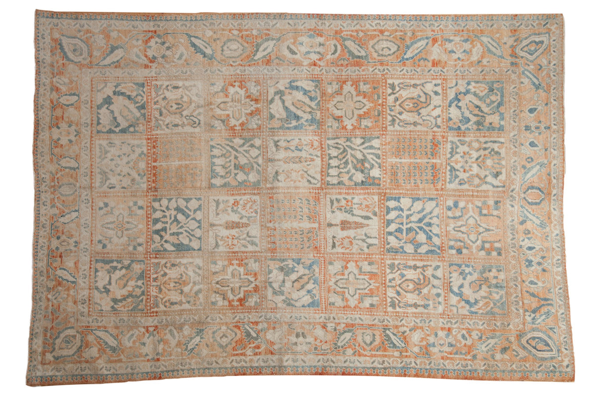 Distressed Turkish Bakhtiari rug with four-seasons panels in pale terra cotta, ivory, and pale denim blue.
