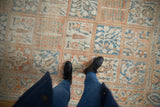 Evenly worn, low pile of a distressed Turkish carpet with terracotta and denim blue panels.