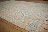 Angled view of the vintage Bakhtiari carpet's low pile and repeating panel design.