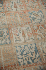 Angled close-up of the distressed, low-pile texture on a vintage Turkish Bakhtiari carpet.