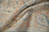 Evenly worn, hand-knotted pile of a vintage Turkish rug in pale terracotta and denim blue.