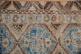 Distressed vintage Oushak runner with sky blue geometric guls and running T border.