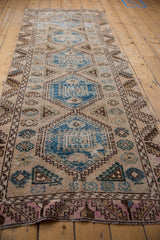 Distressed sky blue geometric medallions, guls, and worn texture on vintage Oushak runner.